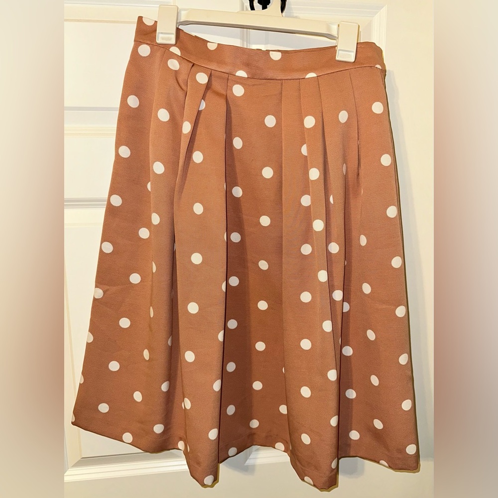 Pink and white polkadot skirt.
